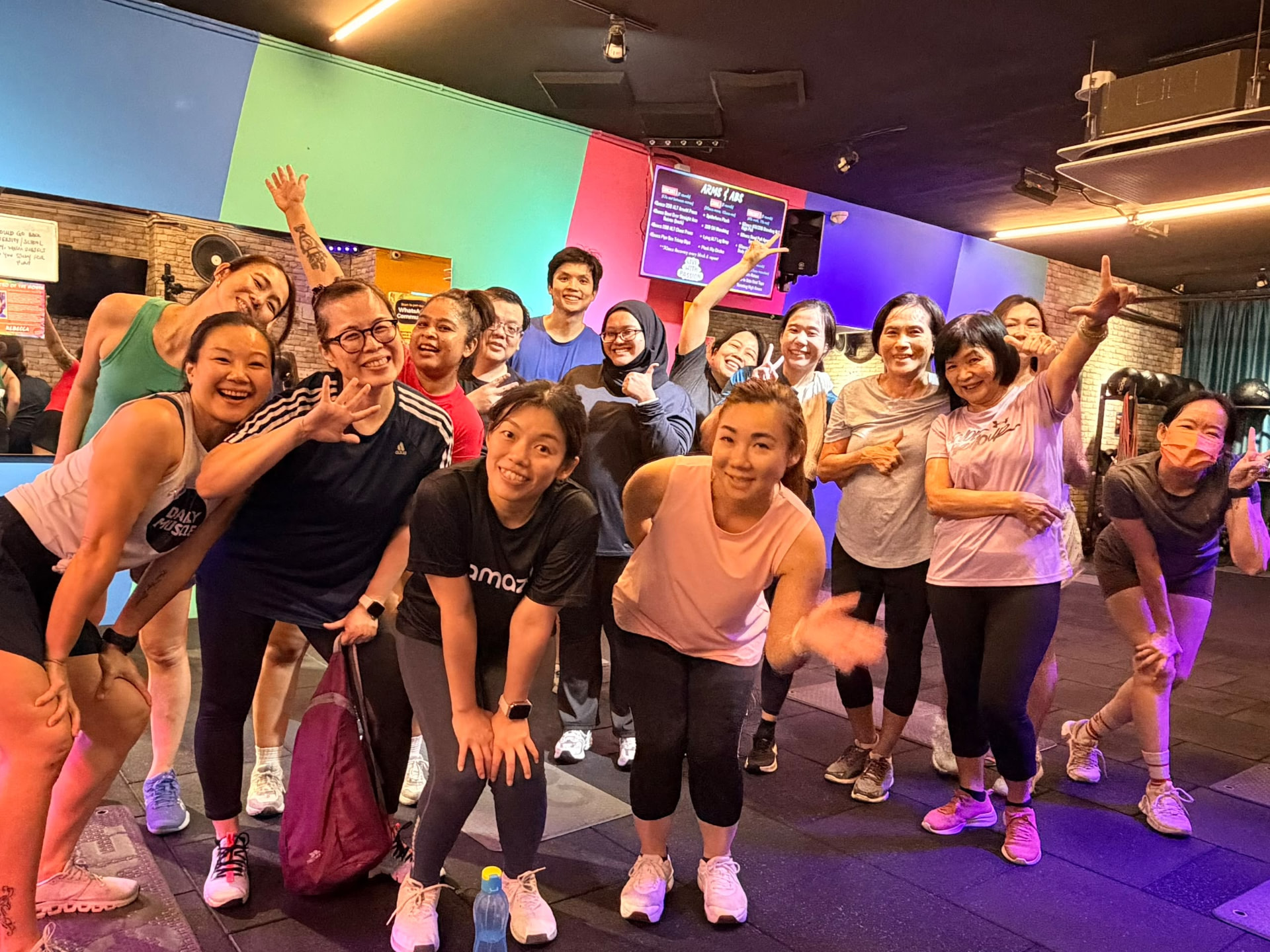 Smiling group of members after a coached group class at DailyMuscle LightHouse